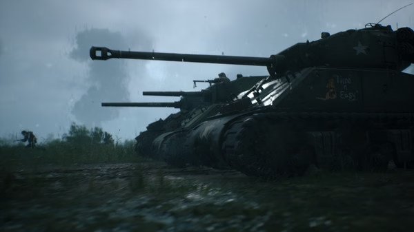 Hell Let Loose screenshot: Three tanks lined up in a rainy field, with soldiers visible in the background.