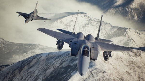 ACE COMBAT 7: SKIES UNKNOWN screenshot showing two fighter jets soaring over snow-covered mountains under a cloudy sky.