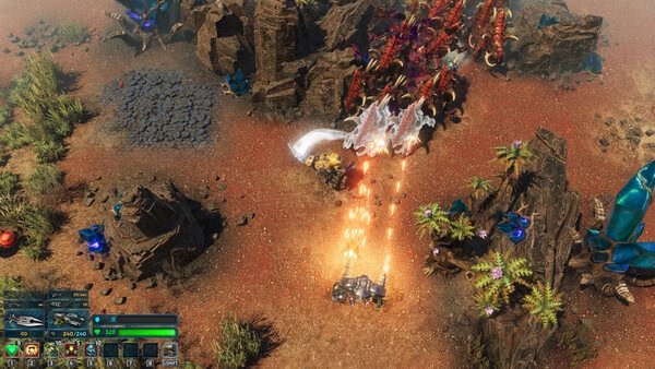The Riftbreaker screenshot: A mech battles a swarm of alien creatures in a rocky, desert terrain with vibrant flora scattered around.