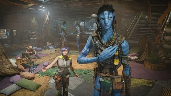 Screenshot from Avatar: Frontiers of Pandora showing a Na'vi and a human in a bustling room with various characters and objects.