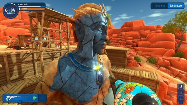 PowerWash Simulator screenshot: A large stone statue being cleaned with a decorated power washer in a desert setting.