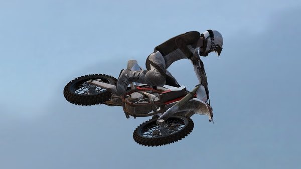 MX Bikes screenshot: A motocross rider wearing a helmet and gear performs a mid-air jump against a clear sky.