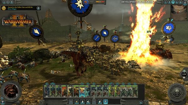 Screenshot from Total War: WARHAMMER II showing a battlefield with dinosaurs and soldiers in combat near a towering flame.