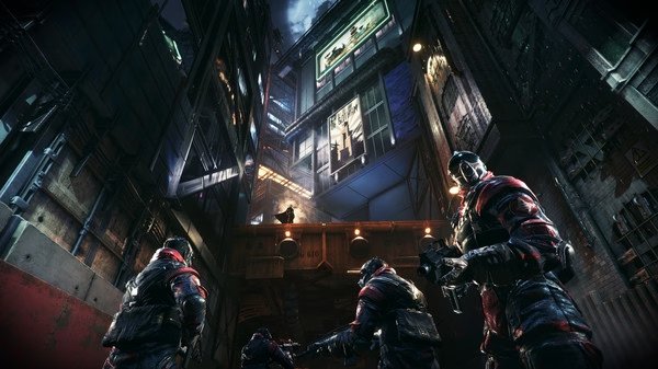 Batman: Arkham Knight screenshot of Batman observing armed enemies in a dark city alley with neon-lit buildings.