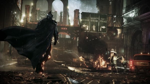 Batman: Arkham Knight screenshot showing Batman walking towards enemies in a rainy, dimly lit city street with damaged surroundings.