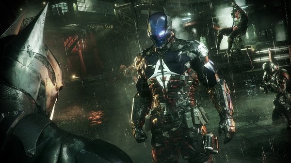 Batman: Arkham Knight screenshot showing Batman facing the Arkham Knight in a rain-soaked industrial setting with enemies in the background.