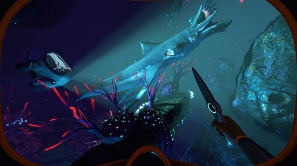 Screenshot from Subnautica: Below Zero showing a diver's view of a large sea creature and a small submarine underwater.