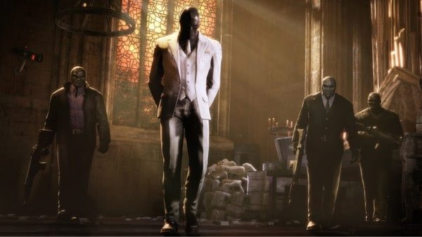Batman: Arkham Origins screenshot showing Black Mask walking in a cathedral, flanked by armed henchmen under dramatic lighting.
