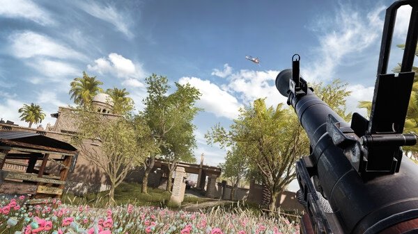 Screenshot from Insurgency: Sandstorm showing a rocket launcher aimed at a flying helicopter in a lush, vibrant garden setting.