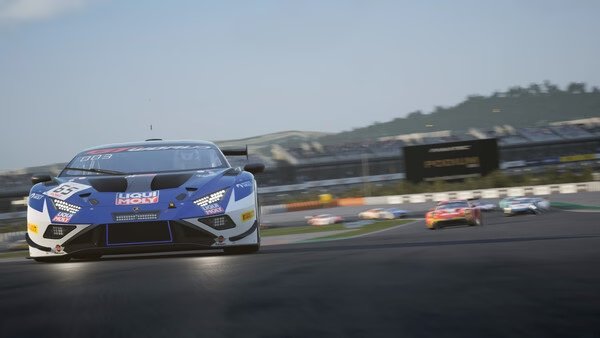 Race cars speeding on a track in Assetto Corsa Competizione. The screenshot shows a close-up of a blue car in front.