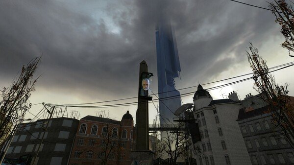 Half-Life 2 screenshot: A cityscape with a tall tower displaying a man's face, surrounded by ominous clouds and urban buildings.