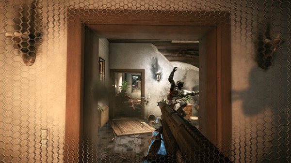 Crysis 2 Remastered screenshot: A player aims a rifle at an enemy in a damaged room, with smoke and debris visible through a mesh barrier.