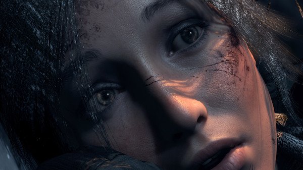 Screenshot from Rise of the Tomb Raider showing a close-up of Lara Croft's face, highlighting her determined expression and battle-worn features.
