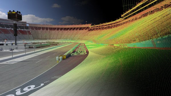 A screenshot from iRacing showing a race track under development with colorful laser scan data mapping the surface.