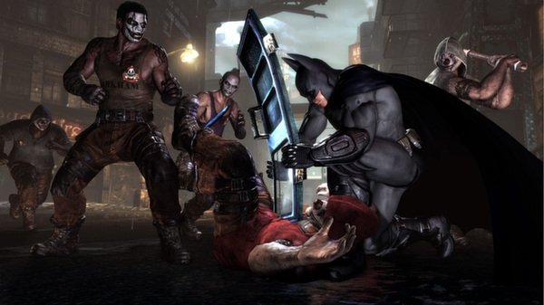 Batman: Arkham City screenshot. Batman blocks an incoming attack with a shield while surrounded by multiple thugs in a dark alley.