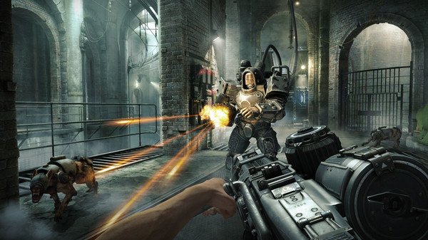 Screenshot from Wolfenstein: The Old Blood showing a player firing at an armored enemy in a dimly lit industrial area.