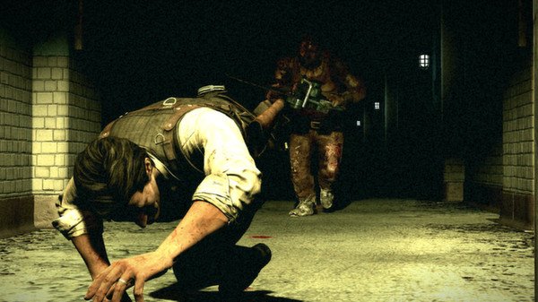 Screenshot from The Evil Within: A character crawls through a dim hallway, pursued by a large, menacing figure wielding a weapon.