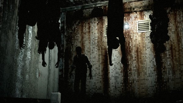 A screenshot from The Evil Within showing a dark, grimy room with hanging corpses and a silhouetted figure walking below.