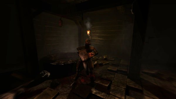 Screenshot from Amnesia: The Dark Descent showing a dimly lit room with a figure holding a torch near a wooden table and scattered objects.