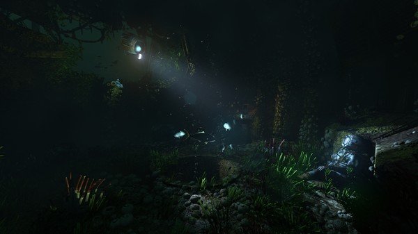 Screenshot from SOMA showing an underwater scene with a diver in a suit sitting amidst glowing sea plants and mysterious lights.