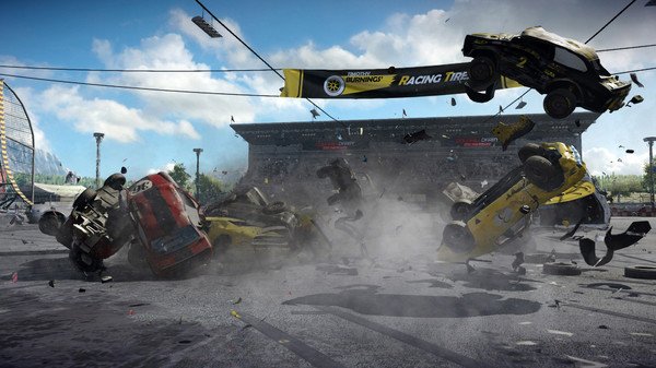 Wreckfest screenshot: multiple cars collide in a chaotic crash on a racetrack, with debris scattered and dust rising.