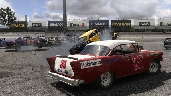 Wreckfest screenshot: A chaotic crash scene with multiple cars colliding on a racetrack, including a prominent red and white car numbered 29.