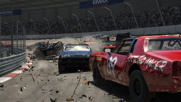 Wreckfest screenshot showing a chaotic demolition derby with damaged cars colliding, debris flying, and a packed stadium in the background.