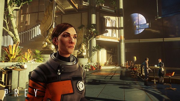 Screenshot from Prey showing a character in a spacesuit inside a futuristic lobby, with Earth visible through large windows.