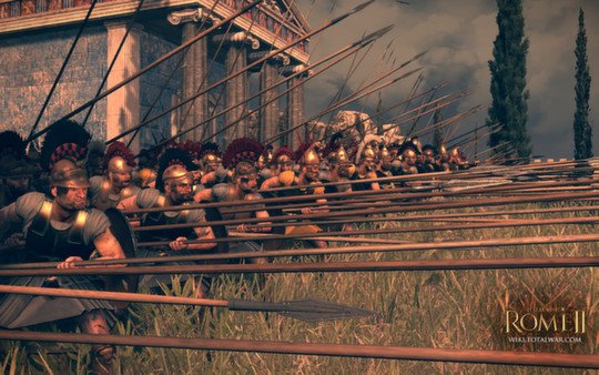 A phalanx of soldiers with long spears stands ready in front of a temple in this Total War: Rome II - Emperor Edition screenshot.