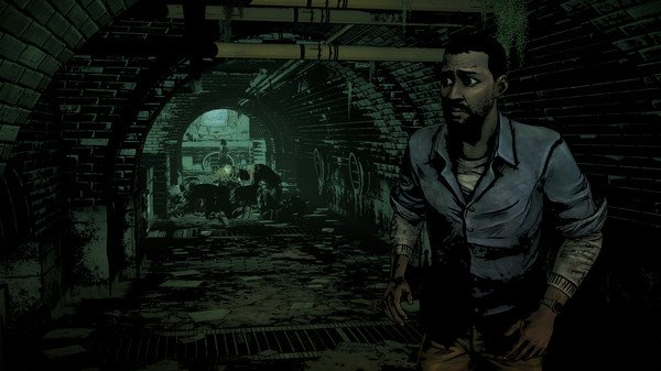 A screenshot from The Walking Dead: The Telltale Definitive Series shows a character walking through a dark, eerie tunnel.