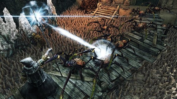 Screenshot from Dark Souls II: Scholar of the First Sin, showing a player character casting magic at several attacking spiders on a wooden bridge.