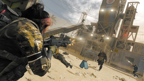 Call of Duty: Modern Warfare III screenshot: A soldier engages enemies near an industrial building in a desert setting.