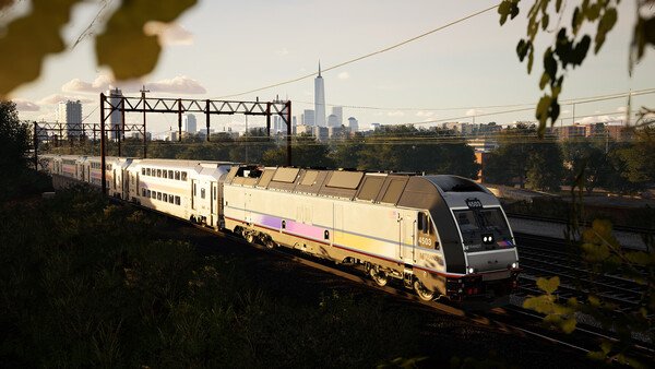 Train Sim World 6 screenshot: A modern passenger train travels along tracks with a city skyline visible in the background.
