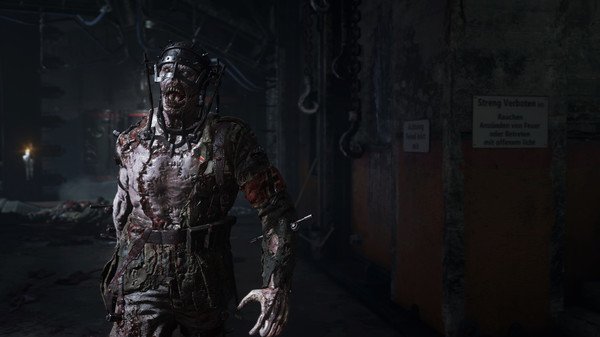 A Call of Duty: WWII screenshot showing a gruesome zombie in a dark, industrial setting with eerie lighting and machinery.