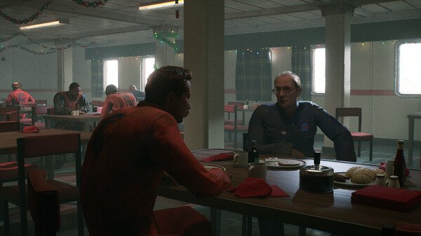 Screenshot from Still Wakes the Deep: two men in work attire converse at a table in a dimly lit cafeteria setting.