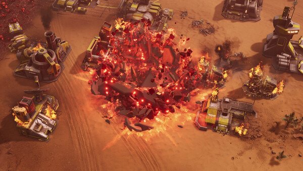 A Tempest Rising screenshot showing a fiery explosion destroying buildings in a desert-themed battlefield environment.