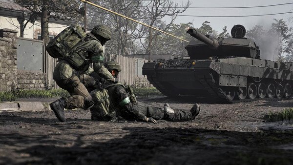Two soldiers in combat gear assist an injured comrade near a tank in a WARDOGS game screenshot showing a war-torn environment.